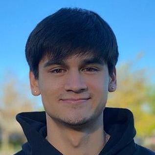 Matthew outdoors with a closed smile