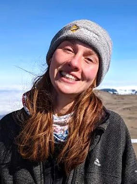 Abi outdoors with a smile