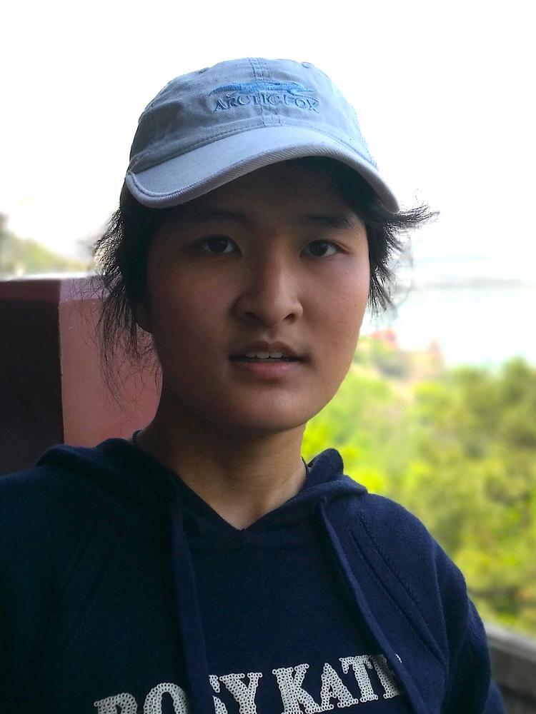 Jiayu outdoors with a hat