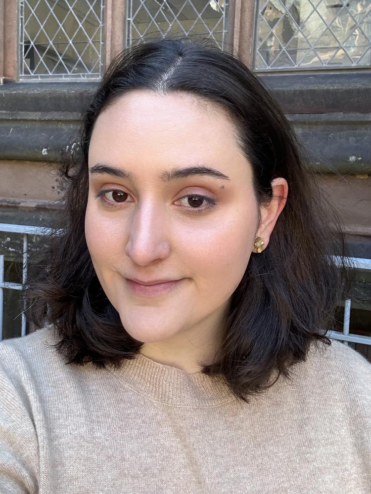 Marcela in front of a window